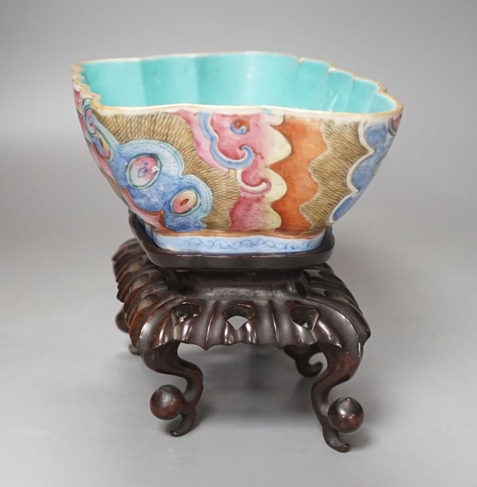 A 19th century Chinese enamelled porcelain ‘butterfly’ bowl, hongmu stand, 21 cms wide x 8 cms high.